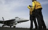 Illustrative: In this Wednesday, March 22, 2017 photograph, crew direct an F-18 on the USS George H.W. Bush as it travels through the Persian Gulf. (AP Photo/Jon Gambrell)