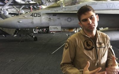 In this Wednesday, March 22, 2017 photograph, Lt. Cmdr. William Vuillet speaks to The Associated Press on board the USS George H.W. Bush as it travels through the Persian Gulf. (AP Photo/Jon Gambrell)