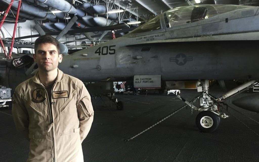 In this Wednesday, March 22, 2017 photograph, Lt. Cmdr. William Vuillet speaks to The Associated Press on board the USS George H.W. Bush as it travels through the Persian Gulf. (AP Photo/Jon Gambrell) In this Wednesday, March 22, 2017 photograph, Lt. Cmdr. William Vuillet speaks to The Associated Press on board the USS George H.W. Bush as it travels through the Persian Gulf. (AP Photo/Jon Gambrell)