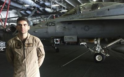 In this Wednesday, March 22, 2017 photograph, Lt. Cmdr. William Vuillet speaks to The Associated Press on board the USS George H.W. Bush as it travels through the Persian Gulf. (AP Photo/Jon Gambrell)