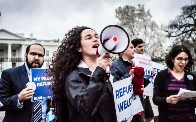 Activist Michele Freed joins other young professionals in front of the White House on Wednesday, March 1, 2017, to share stories of family members who were refugees or immigrants and wouldn’t be here if the U.S. hadn’t opened its doors to them. The action was organized by HIAS, the global Jewish nonprofit that protects refugees. (Katie Jett Walls)