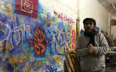 Street artist Dan Groover in his studio in Talpiot, Jerusalem, March 14, 2017 (Jessica Steinberg/Times of Israel)