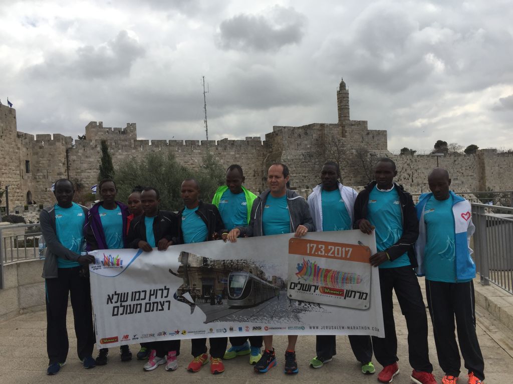 Jerusalem mayor Nir Barkat with the visiting, premier African runners before a warmup run outside Jaffa Gate, ahead of the Friday, March 17, 2017 Jerusalem Marathon (Jessica Steinberg/Times of Israel)