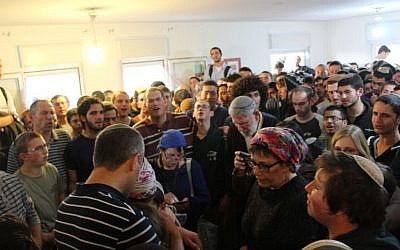 Bini Eldar (L) speaking to protesters gathered in his house in the West Bank Ofra settlement, February 28, 2017. (Raoul Wootliff/Times of Israel)