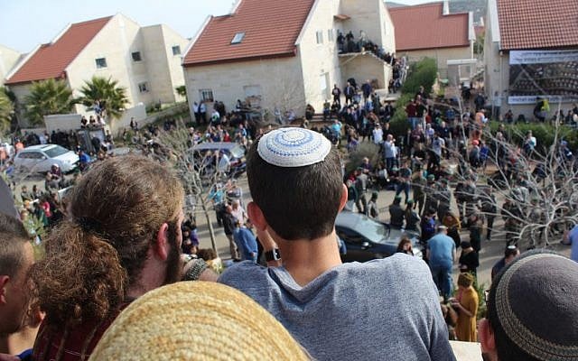 Protester look down from the balcony of a building slated to be demolished in the West Bank Ofra settlement, February 28, 2017. (Raoul Wootliff/Times of Israel)