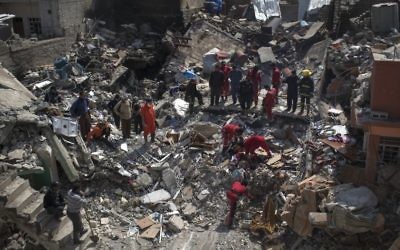 Civil protection rescue team work on the debris of a destroyed house to recover the body of people killed during fights between Iraq security forces and Islamic State on the western side of Mosul, Iraq, Friday, March 24, 2017. (AP Photo/Felipe Dana)