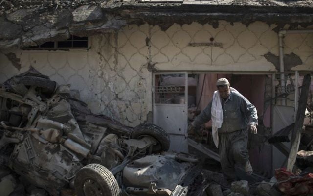 A man exits house damaged during fights between Iraq security forces and Islamic State on the western side of Mosul, Iraq, Friday, March 24, 2017. (Felipe Dana/AP) A man exits house damaged during fights between Iraq security forces and Islamic State on the western side of Mosul, Iraq, Friday, March 24, 2017. (Felipe Dana/AP)