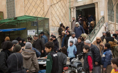 This image released by Islamic State-affiliated Aamaq news agency in March 2017 shows civilians in Raqqa, Syria. (Aamaq news agency via AP)