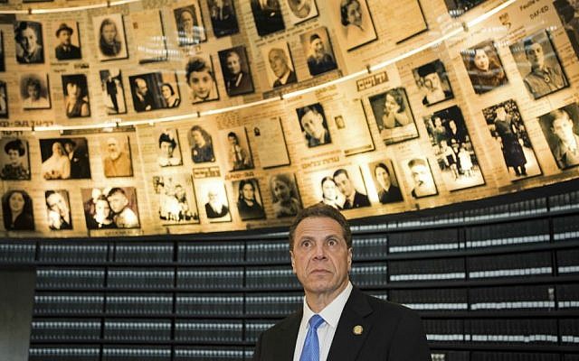 New York Governor Andrew Cuomo looks at photographs of Jews who were killed during the Holocaust, in the Hall of Names at Yad Vashem Holocaust Museum, in Jerusalem, Sunday, March 5, 2017. (AP Photo/Dan Balilty)