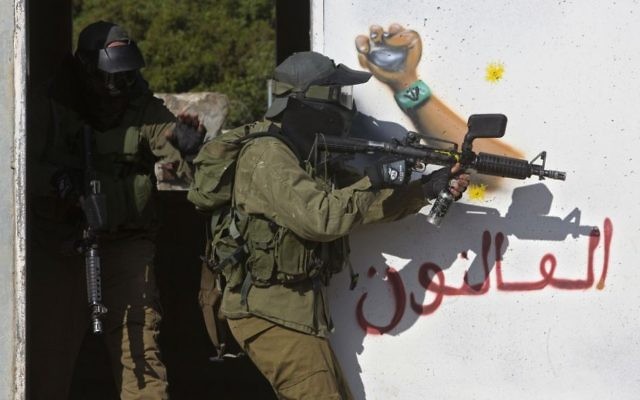 In this Wednesday, March 29, 2017 photo, Israeli soldiers train with paintball guns during a drill at an Army base near Elyakim, Israel. (AP /Sebastian Scheiner) In this Wednesday, March 29, 2017 photo, Israeli soldiers train with paintball guns during a drill at an Army base near Elyakim, Israel. (AP /Sebastian Scheiner)