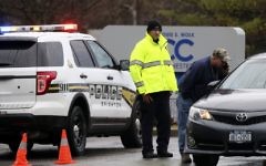 Police officers investigate a bomb threat outside the Louis S. Wolk Jewish Community Center of Greater Rochester in Brighton, NY on Tuesday, March 7, 2017. (Tina Macintyre-Yee/Democrat & Chronicle via AP)