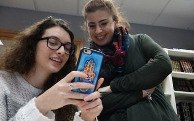 Illustrative: Checking out 'likes' on social media. (Dana Wachter/Times of Israel)