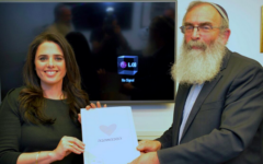 Former Justice Minister Ayalet Shaked with Tzohar founder Rabbi David Stav holding a new prenuptial agreement developed by the organization for Israeli Jewish couples to sign ahead of weddings in this 2017 file photo. (Courtesy)