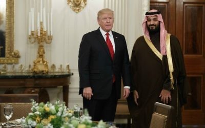 In this Tuesday, March 14, 2017 photo, US President Donald Trump stands with Saudi Defense Minister and Deputy Crown Prince Mohammed bin Salman before lunch in the State Dining Room of the White House in Washington.  (AP Photo/Evan Vucci)