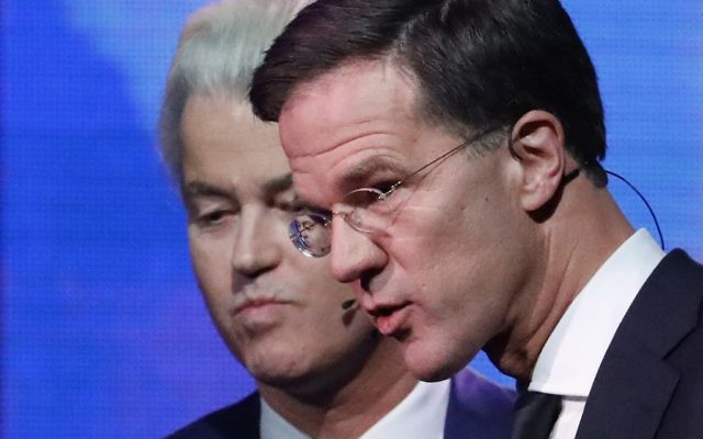 Right-wing populist leader Geert Wilders and Dutch Prime Minister Mark Rutte, right, leave the stage after a national televised debate. (Yves Herman/AP)