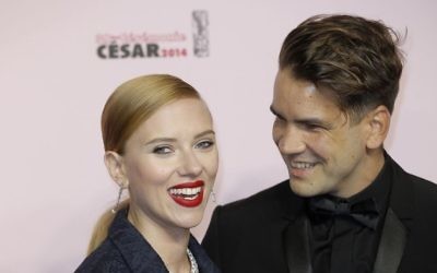 In this February 28, 2014, photo, US actress Scarlett Johansson, left, and her partner Romain Dauriac arrive at the 39th French Cesar Awards Ceremony, in Paris. (AP Photo/Lionel Cironneau, File)