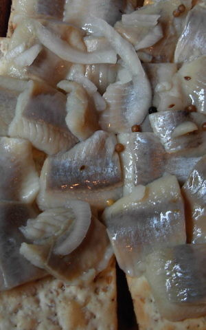 Pickled herring on crackers. (Wikimedia commons/Jonathunder)