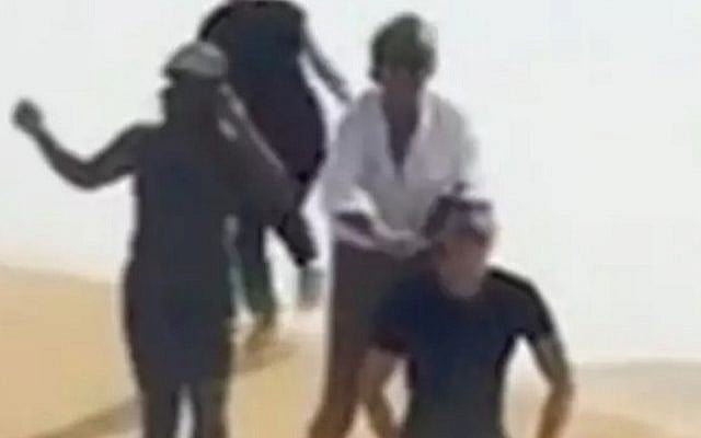 Rod Stewart ( in white shirt) seen doing a 'mock execution' of a friend in a parody of Islamic State executions, in a still image from a short Instagram clip posted by Stewart's wife. The singer later apologized for the re-enactment. (Screen capture/ Youtube)