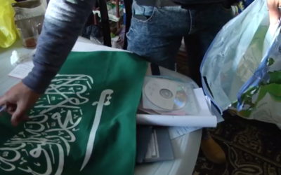 A Hamas flag and other pieces of evidence are collected by police officers from the home of an East Jerusalem assailant who stabbed two police officers on March 13, 2017. (Screen capture/Israel Police)