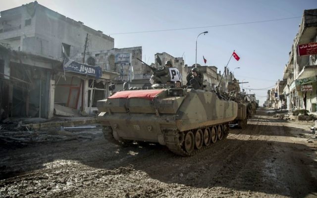 In this February 22, 2015, file photo, Turkish military vehicles and tanks drive in the Syrian town of Ayn al-Arab, also known as Kobani, Syria. (AP Photo/Mursel Coban, Depo Photos, File) In this February 22, 2015, file photo, Turkish military vehicles and tanks drive in the Syrian town of Ayn al-Arab, also known as Kobani, Syria. (AP Photo/Mursel Coban, Depo Photos, File)