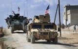 This Tuesday, March 7, 2017 frame grab from video shows US forces patrol on the outskirts of the Syrian town, Manbij, a flashpoint between Turkish troops and allied Syrian fighters and US-backed Kurdish fighters, in al-Asaliyah village, Aleppo province, Syria. (Arab 24 network, via AP, File)