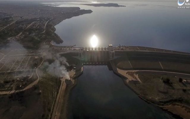 This still image taken from drone footage posted online Monday, March. 27, 2017 shows smoke rising near the Tabqa Dam, in Raqqa, Syria. (Aamaq News Agency via AP) This still image taken from drone footage posted online Monday, March. 27, 2017 shows smoke rising near the Tabqa Dam, in Raqqa, Syria. (Aamaq News Agency via AP)