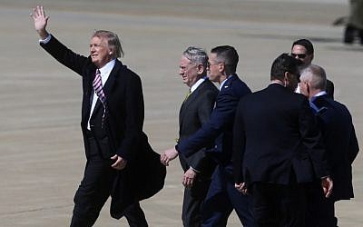 President Donald Trump, accompanied by Defense Secretary Jim Mattis, and others, waves to a small crowd of supporters upon his arrival at Langley Air Force Base in Hampton, Va., Thursday, March 2, 2017. (AP/Jason Hirschfeld) 