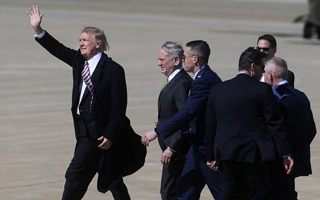 President Donald Trump, accompanied by Defense Secretary Jim Mattis, and others, waves to a small crowd of supporters upon his arrival at Langley Air Force Base in Hampton, Va., Thursday, March 2, 2017. (AP/Jason Hirschfeld) 
