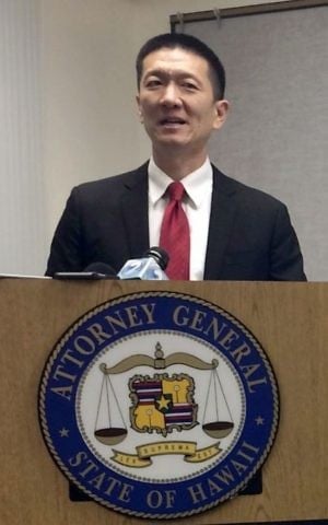 Hawaii Attorney General Doug Chin speaks at a news conference in Honolulu announcing the state of Hawaii has filed a lawsuit challenging President Donald Trump's travel ban, February 3, 2017. (AP Photo/Audrey McAvoy, File)