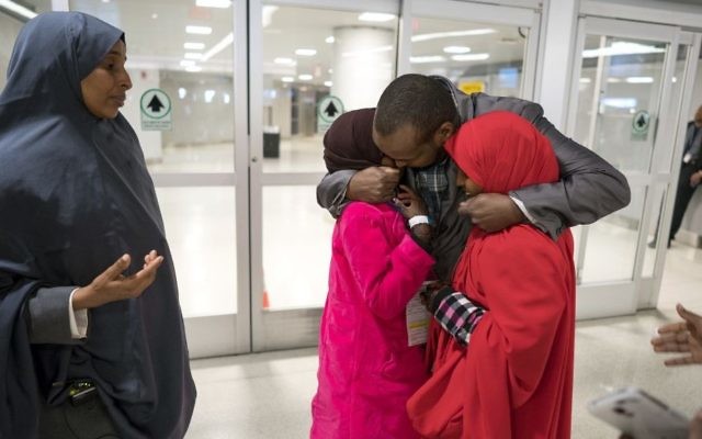 Ismail Issack, father of Miski Shalle, 11, and Muzamil Shalle, 14, embraces his children as their mother Halima Mohamed, far left, looks on as they reunite for the first time in seven years at John F. Kennedy International Airport in New York Wednesday, March 8, 2017. (AP Photo/Craig Ruttle) Ismail Issack, father of Miski Shalle, 11, and Muzamil Shalle, 14, embraces his children as their mother Halima Mohamed, far left, looks on as they reunite for the first time in seven years at John F. Kennedy International Airport in New York Wednesday, March 8, 2017. (AP Photo/Craig Ruttle)