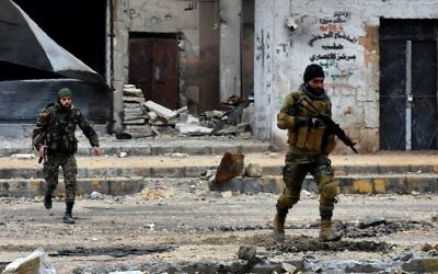 This file photo taken on December 14, 2016 shows Syrian pro-government forces advancing during a military operation in the northern city of Aleppo. (AFP Photo/George Ourfalian)