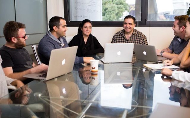 Ron Teicher, CEO of EverCompliant, heads a meeting of company employees. (Courtesy)