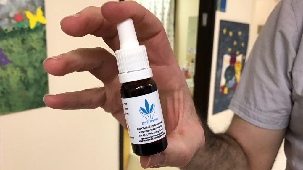 Dr. Adi Aran holds a dropper with a cannabinoid compound at Shaare Zedek Medical Center in Jerusalem, March 2, 2017. (Luke Tress/Times of Israel) Dr. Adi Aran holds a dropper with a cannabinoid compound at Shaare Zedek Medical Center in Jerusalem, March 2, 2017. (Luke Tress/Times of Israel)