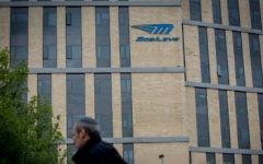 A man walks under the Mobileye logo in Jerusalem, March 13, 2017. (Yonatan Sindel/Flash90)