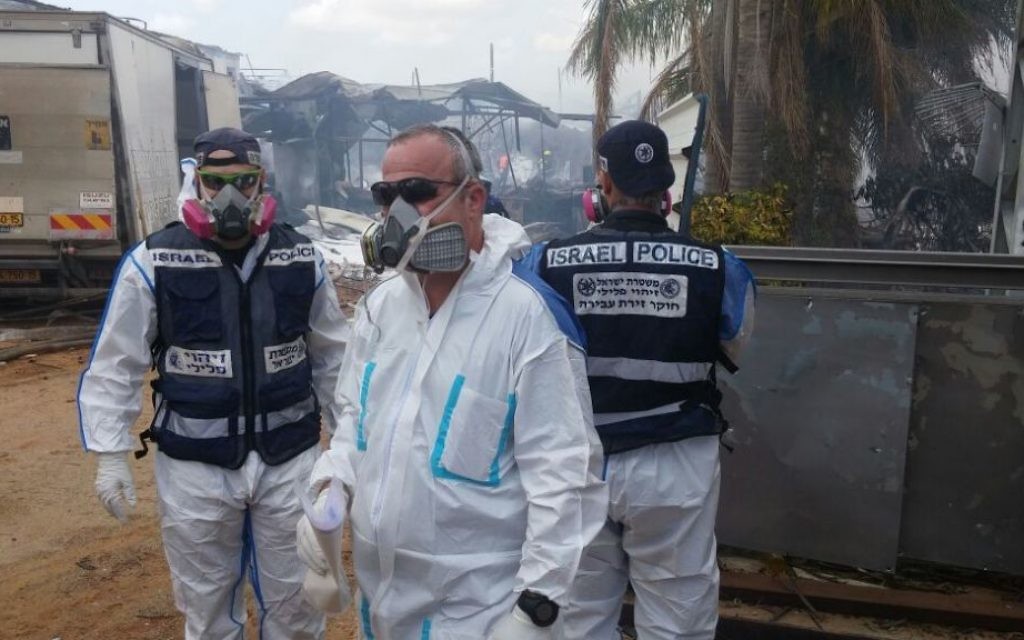 Rescue workers at a fireworks factory in the central Israeli village of Porat battle a blaze that killed at least two, wounded seven and damaged nearby homes. (Israel Police)