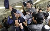FILE - In this March 23, 2009, file photo, Japan's Ichiro Suzuki gets tossed around by teammates during a clubhouse celebration after their 5-3 victory over South Korea in the championship game of the World Baseball Classic, in Los Angeles. (Ted S. Warren/AP/Pool)