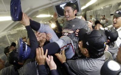 FILE - In this March 23, 2009, file photo, Japan's Ichiro Suzuki gets tossed around by teammates during a clubhouse celebration after their 5-3 victory over South Korea in the championship game of the World Baseball Classic, in Los Angeles. (Ted S. Warren/AP/Pool)