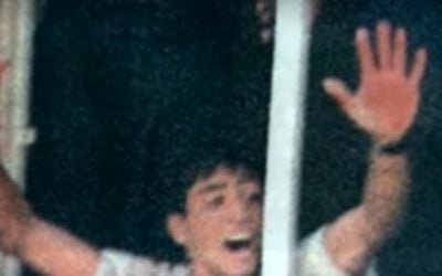 Palestinian Aziz Salha, since released from jail as part of a prisoner exchange for kidnapped Israeli soldier Gilad Shalit, seen at a window showing off his blood-stained hands as a mob below beat to death two Israeli soldiers in Ramallah, October 2000. (YouTube screenshot)