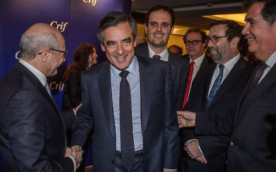 Francois Fillon, with open jacket, shaking hands with CRIF President Francis Kalifat in Paris, March 14, 2017. (Courtesy CRIF via JTA)