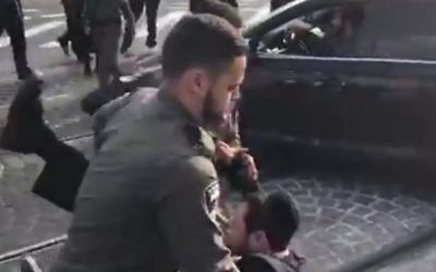 Police arrest an ultra-Orthodox Jewish protester during continuing riots in Jerusalem against the detention of a Torah student for failing to turn up for army conscription. March 20, 2017 (YouTube screenshot)