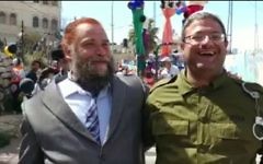 Attorney Itamar Ben Gvir (R) dressed up as IDF solider Elor Azaria, and Lehava leader Bentzi Gopstein dressed up as US President Donald Trump, attend a Purim celebration in the West Bank city of Hebron on March 12, 2017. (screen capture: Channel 10)