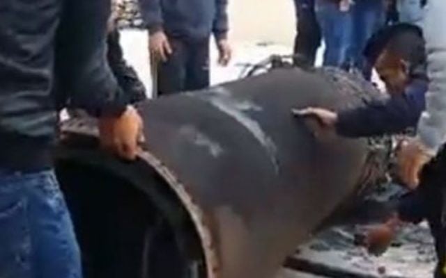 Jordanians inspect the remains of a Syrian missile and an Israeli Arrow interceptor that fell in Jordan on March 17, 2017 (Jordanian government/Petra) Jordanians inspect the remains of a Syrian missile and an Israeli Arrow interceptor that fell in Jordan on March 17, 2017 (Jordanian government/Petra)
