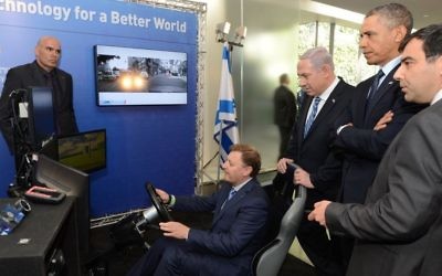 Ziv Aviram, President and CEO of Mobileye, demonstrates the driverless car to Israeli Prime Minister Benjamin Netanyahu (2R) and former US president Barack Obama (C) during an exhibition of technological innovation at the Israel Museum, as Amnon Shashua (R), Mobileye‘s co-founder and chief technology officer, looks on. Jerusalem, March 21, 2013. Photo by Kobi Gideon / GPO /FLASH90