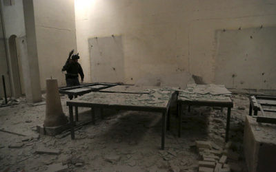 An Iraqi federal policeman inspects the inside of Mosul's heavily damaged museum in western Mosul, Iraq, Wednesday, March 8, 2017. (halid Mohammed/AP)