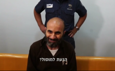 Wissam Zavidat responds to questions from the media during his trial at a Haifa district court in footage released on March 21, 2017. (Screen capture/Walla)