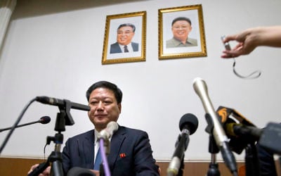 Pak Myong Ho, minister of the North Korean Embassy in China, sits under portraits of the late North Korean leaders Kim Il Sung, left, and Kim Jong Il during a press conference in Beijing, China, Thursday, March 16, 2017. (AP Photo/Ng Han Guan)