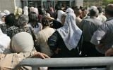 Palestinians queue in front of the Interior Ministry branch in East Jerusalem, July 6, 2008.  (AP Photo/Sebastian Scheiner, File)
