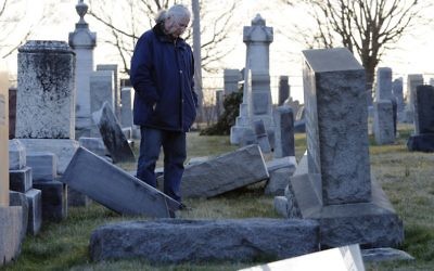 A man looks at fallen tombstones at the Jewish Mount Carmel Cemetery, February 26, 2017, in Philadelphia, PA. (AFP/Dominick Reuter/Getty Images)