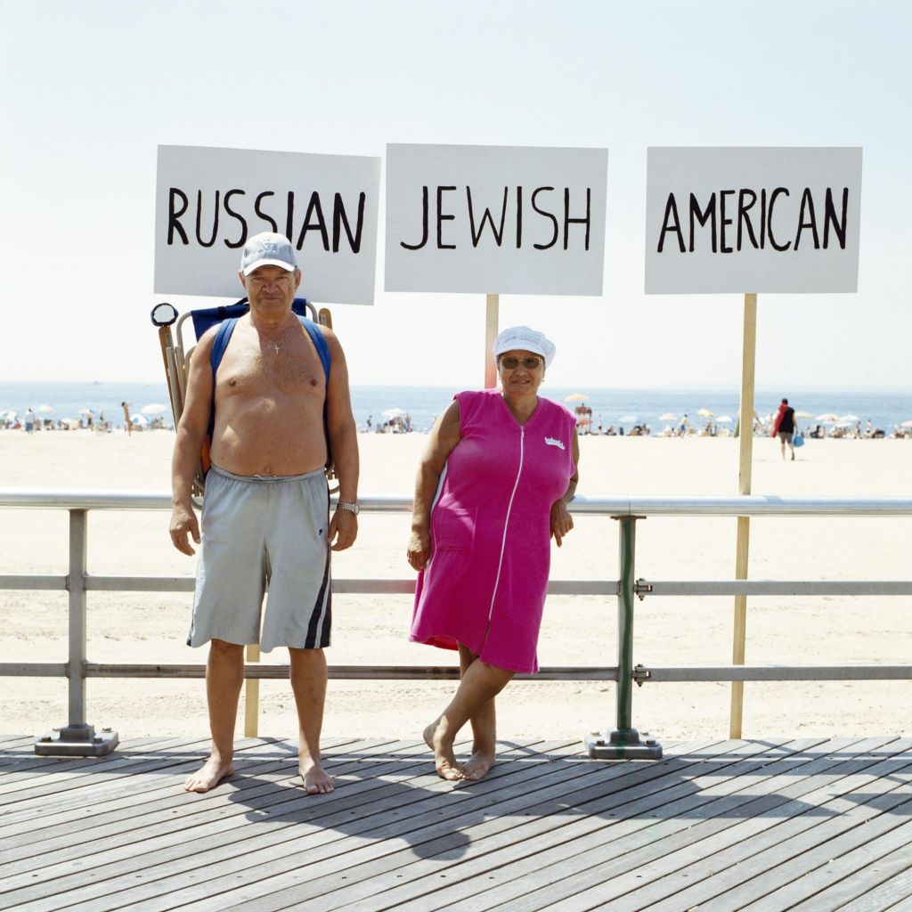 Subjects posing under the signs that best identify them in Alina and Jeff Bliumis's book, 'From Selfie to Groupie.' (Courtesy) Subjects posing under the signs that best identify them in Alina and Jeff Bliumis's book, 'From Selfie to Groupie.' (Courtesy)