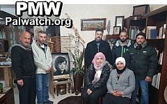 Organizers of the 'Brothers of Dalal' youth camp pose beside photo of terrorist Dalal Mughrabi (PMW)